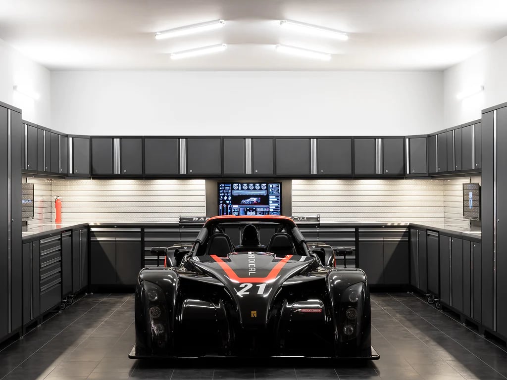 Awesome garage with black race car and cabinets