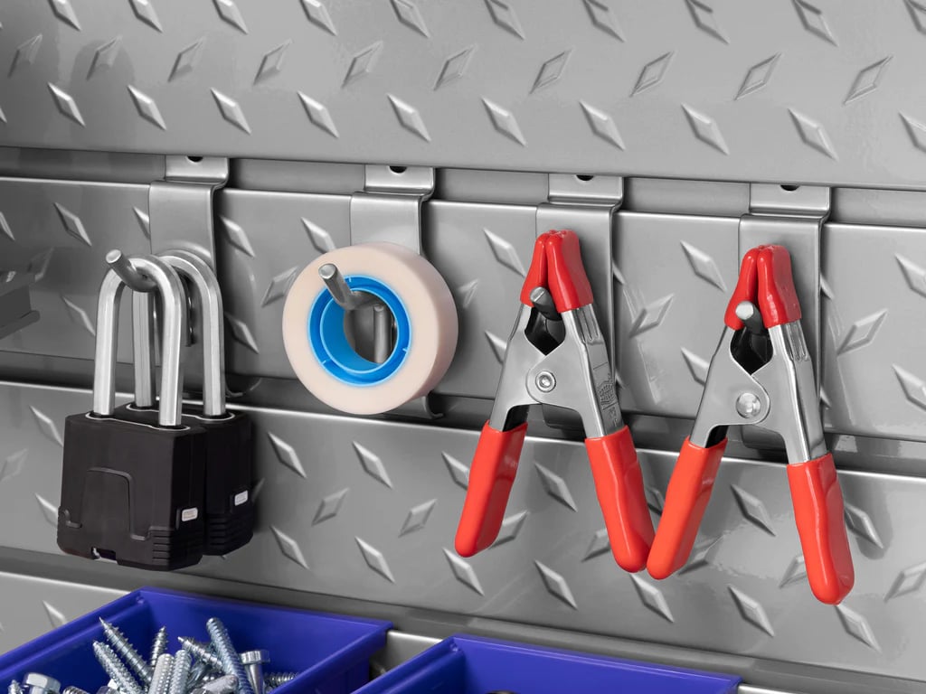 small handyman supplies on hooks on steel slatwall