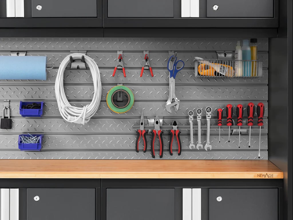 tools and cords neatly hanging on slatwall backsplash of stylish cabinets