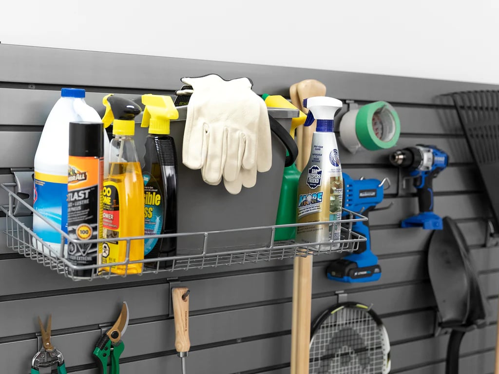 gray slatwall with cleaning supplies on a shelf