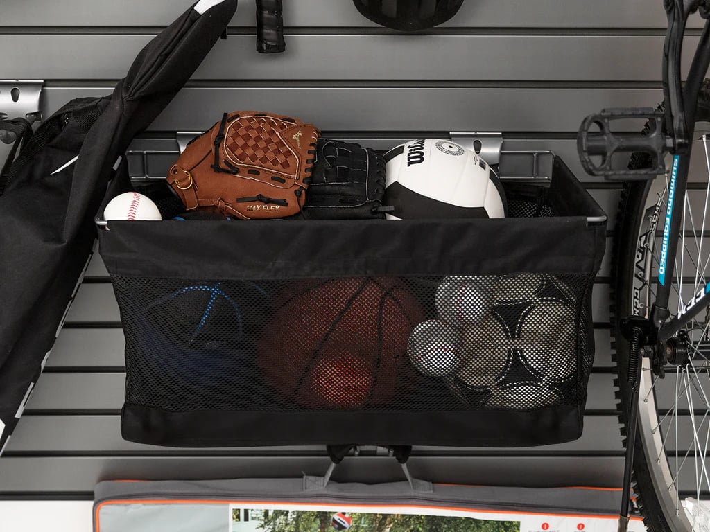 sports equipment in a basket on steel slatwall