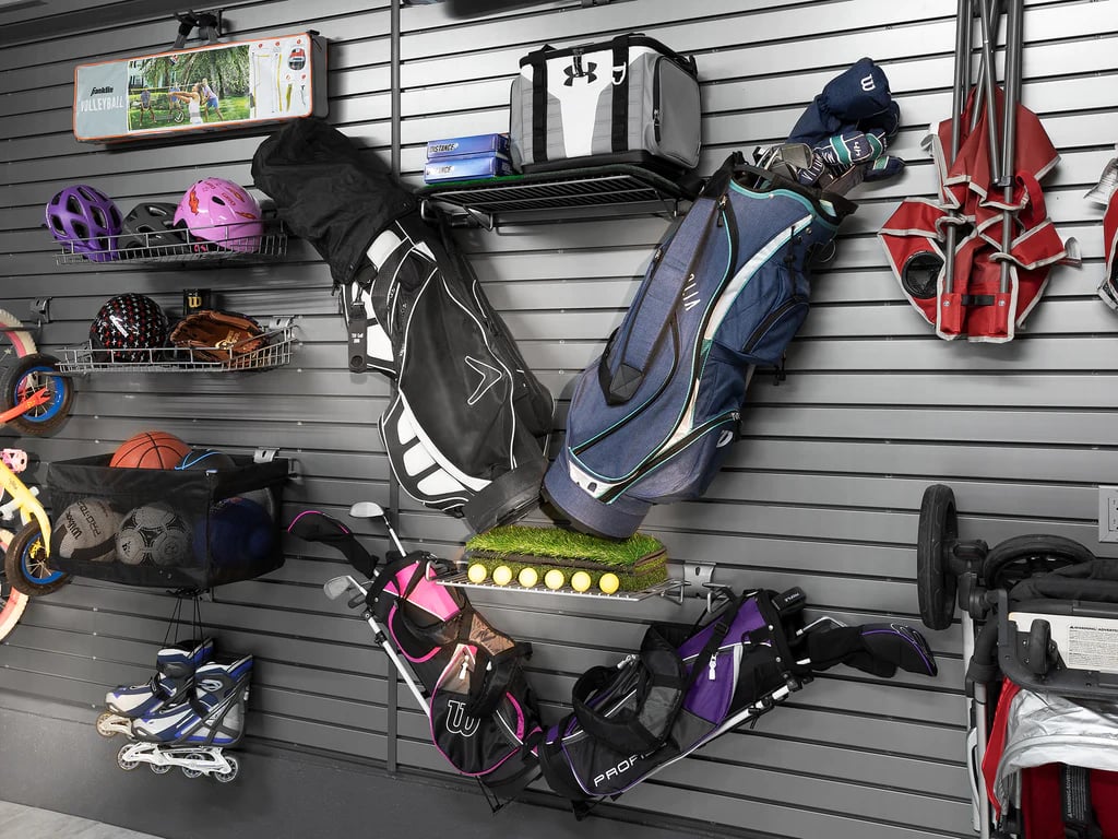 steel slatwall with golf bag and sports equipment hanging