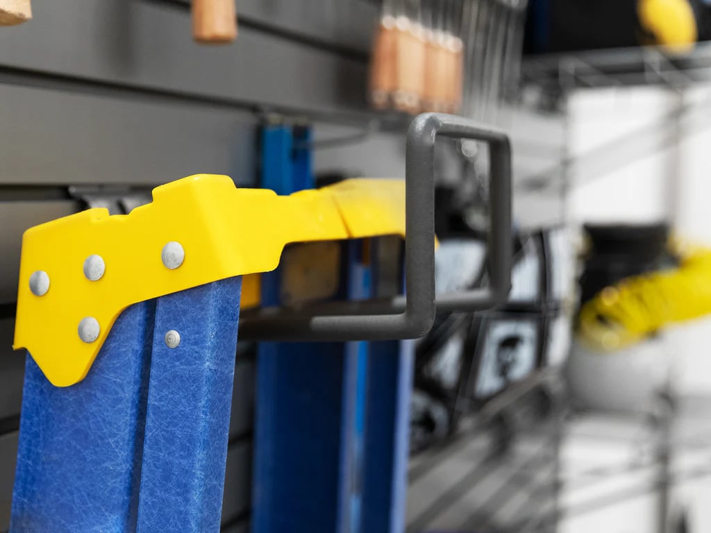 close up of blue and yellow ladder hanging on slatwall hook
