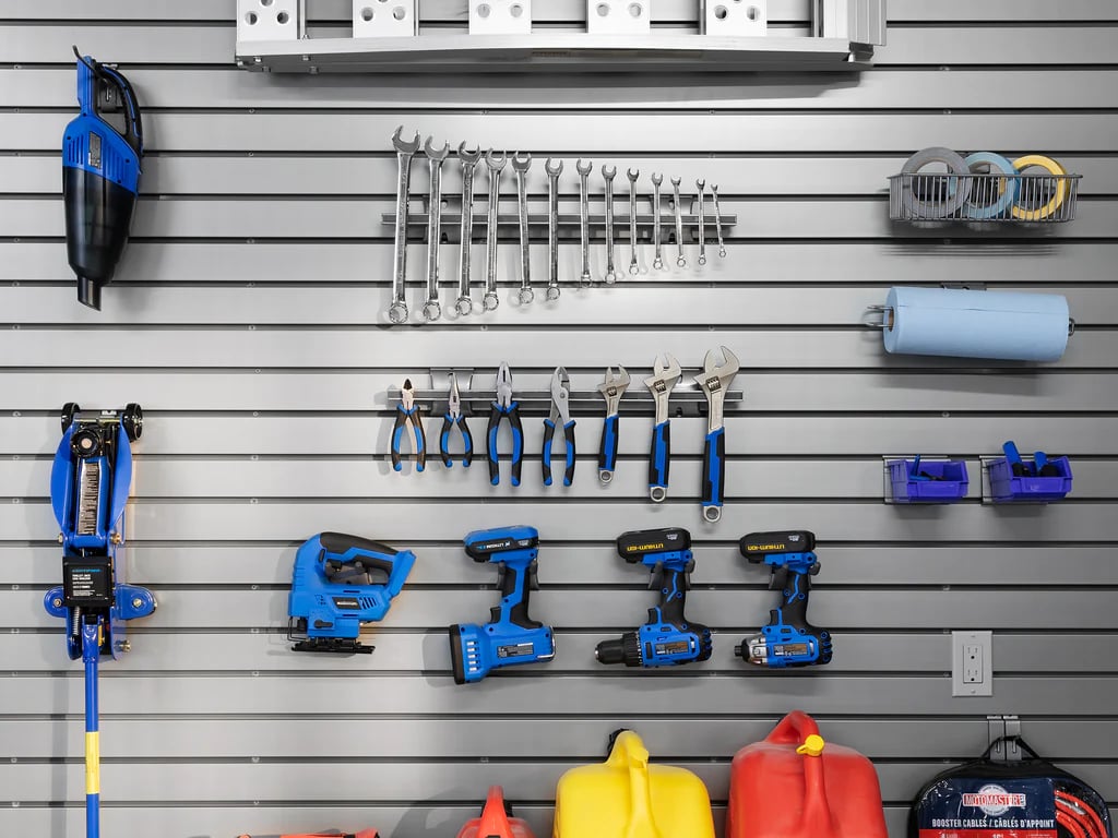 blue tools hanging on gray steel slatwall