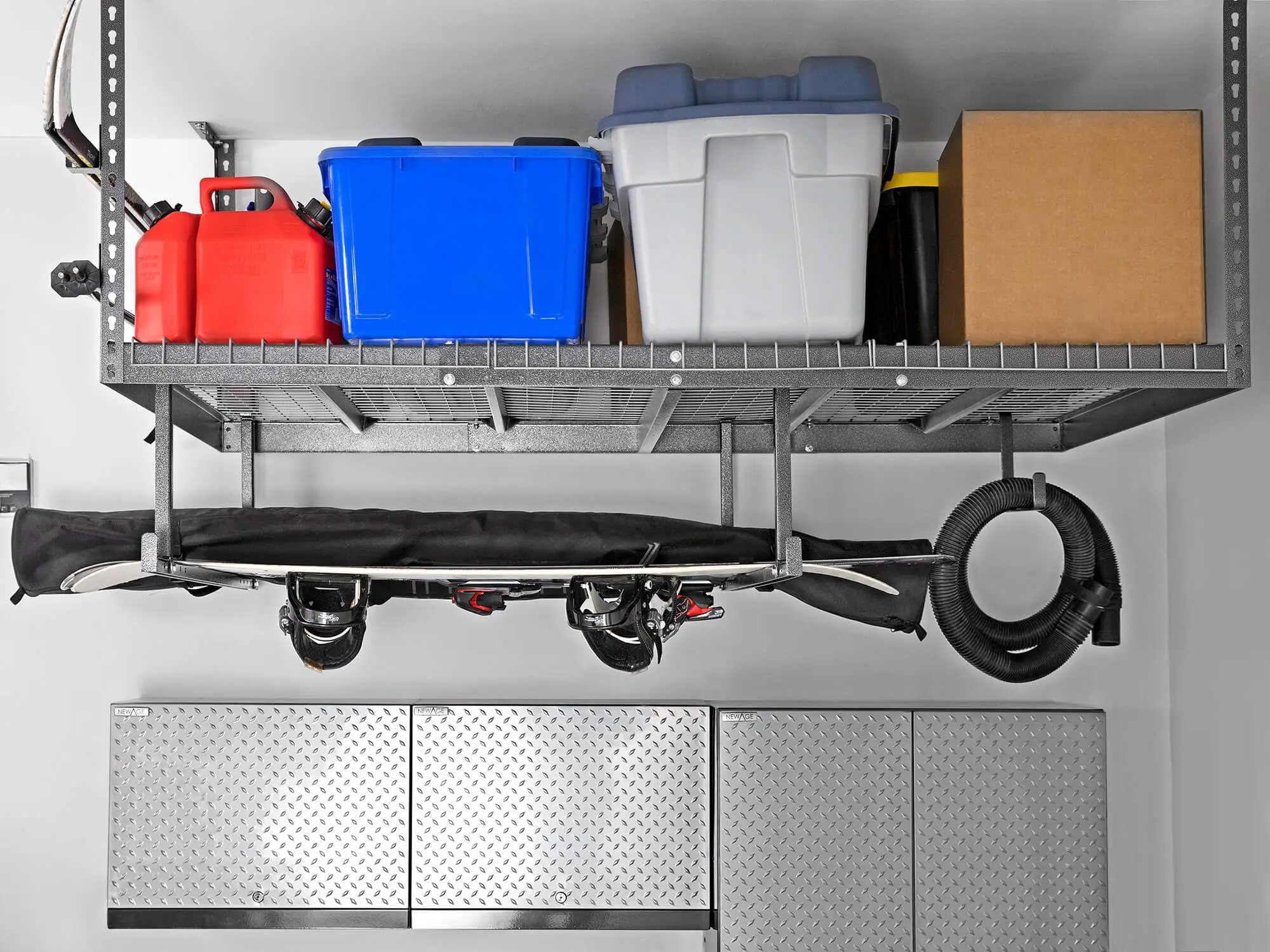 snowboard hanging under ceiling storage rack with bins above