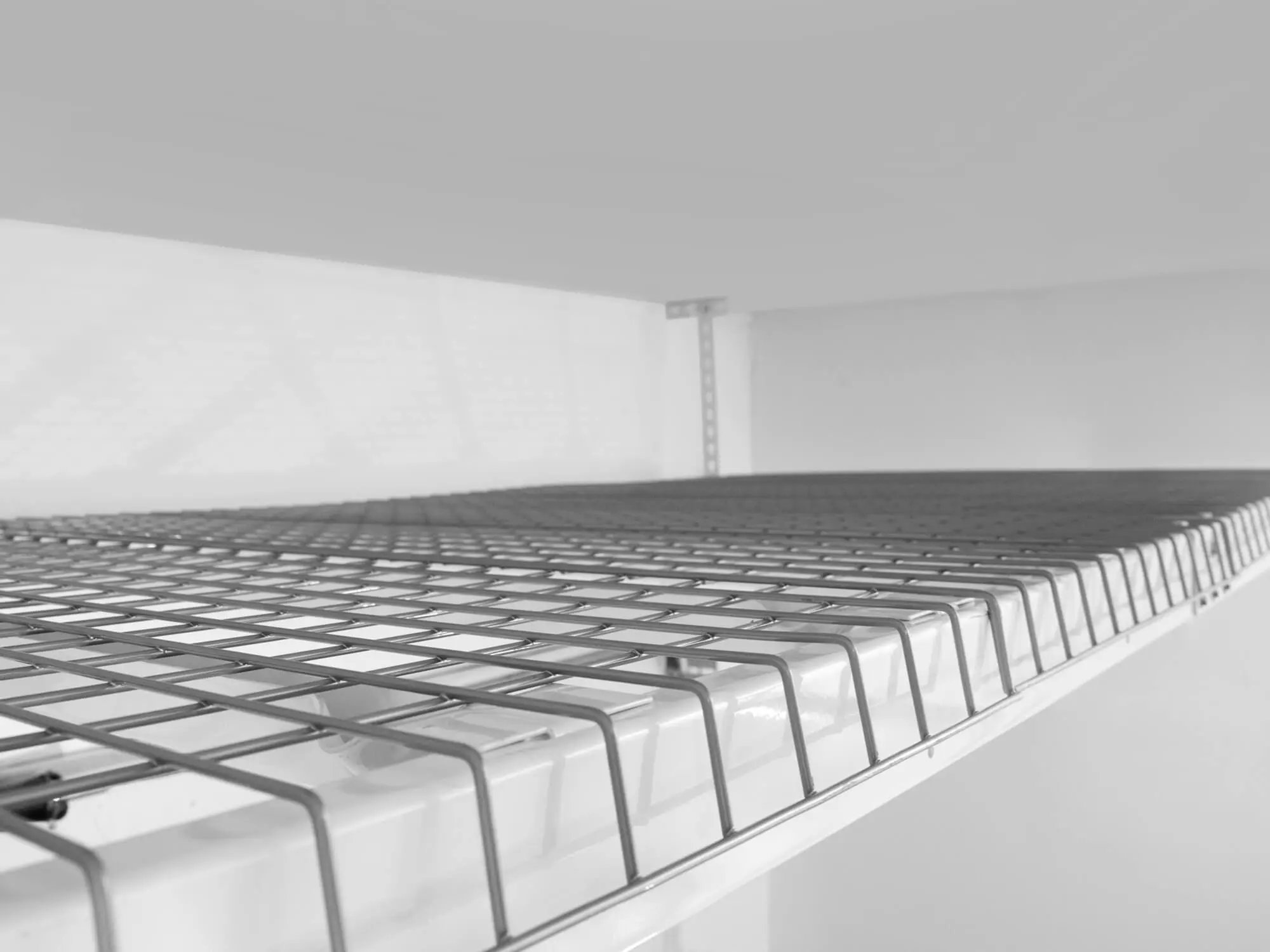 empty white ceiling mounted storage rack