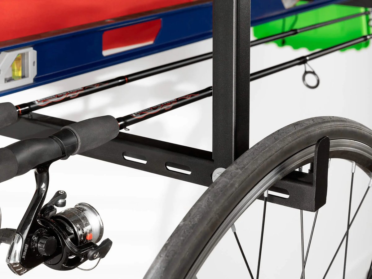 hanging storage solution with fishing rods and bike wheel