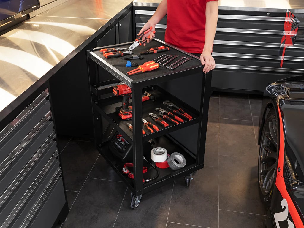 Mechanic rolling tool cart in modern garage