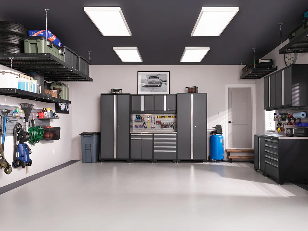 Long view of modern garage with dark cabinets and wall storage
