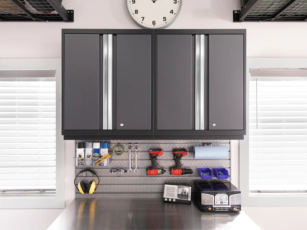 hanging dark storage cabinets with tools hanging on steel slatwall 
