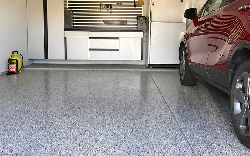 epoxy polyaspartic floor with red car parked on the right side